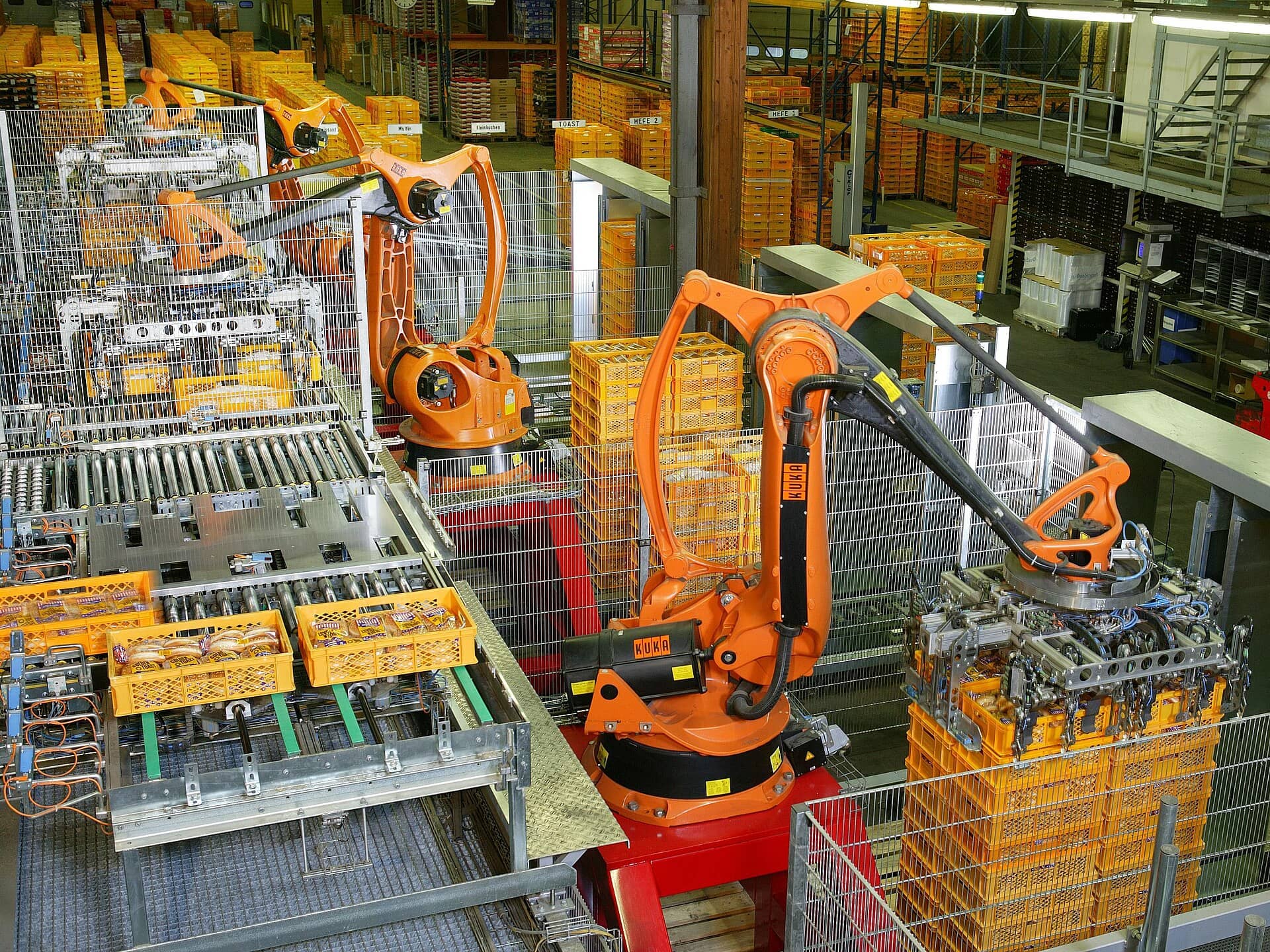 Robôs industriais paletizando produtos em uma linha de automação de fábrica